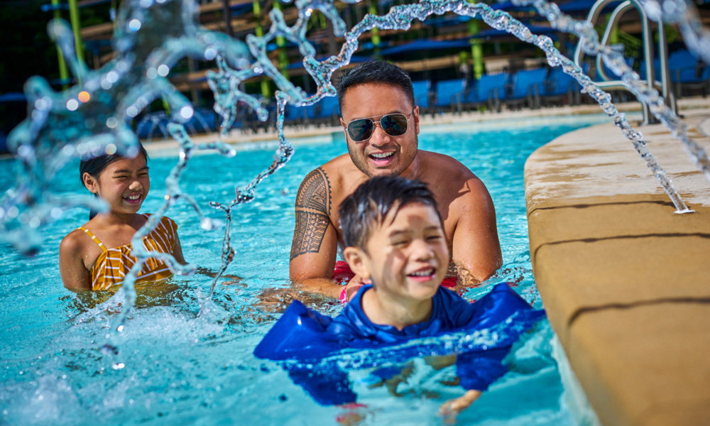 A family enjoying the outdoor pool