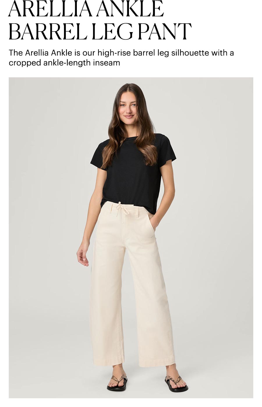 Arellia Ankle Barrel Leg Pant - The Arellia Ankle is our high-rise barrel leg silhouette with a cropped ankle-length inseam. Featuring a woman wearing a pair of cream barrel-leg jeans with a loose-fit black tee and snakeskin flip-flop sandals.