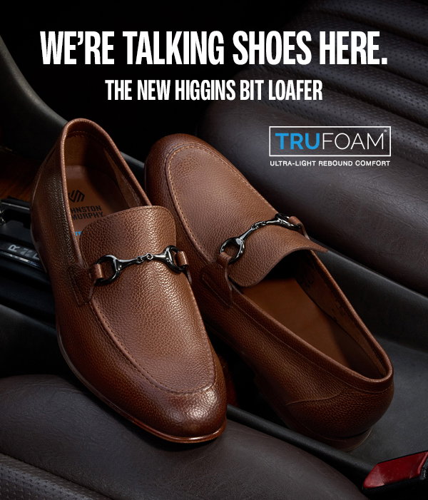 Brown Higgins Bit Loafers with polished gunmetal bit hardware displayed on a leather car seat. Text reads: 
