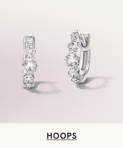 A pair of white metal diamond hoops. Click here to shop hoops