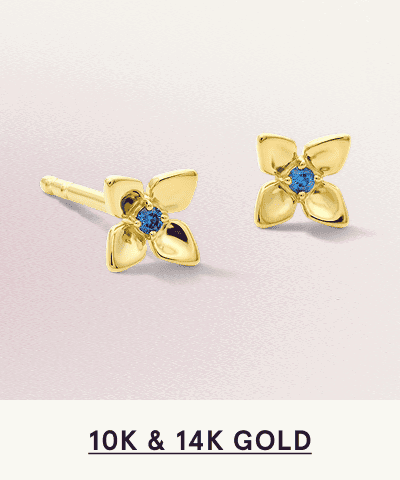 A pair of gold flower shaped studs with blue gemstone accents. Click here to shop 10K and 14K gold 