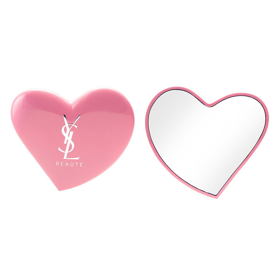 A pink heart-shaped YSL Beauté pocket mirror, shown closed with the white logo and open displaying the mirror side.