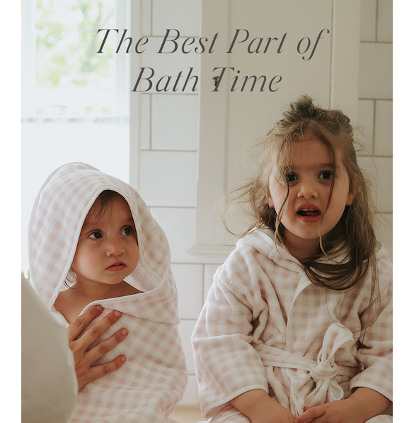 two kids sitting in bath robes