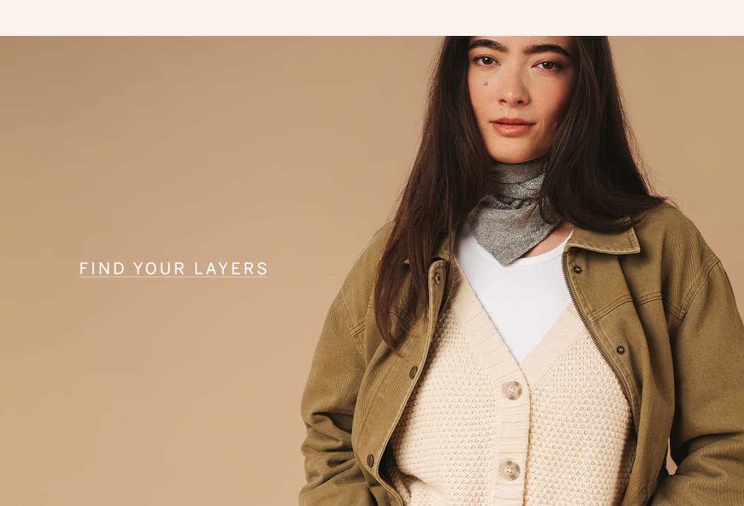 Model wearing layered fall essentials including a jacket, knit cardigan, and scarf with "Find Your Layers" text.