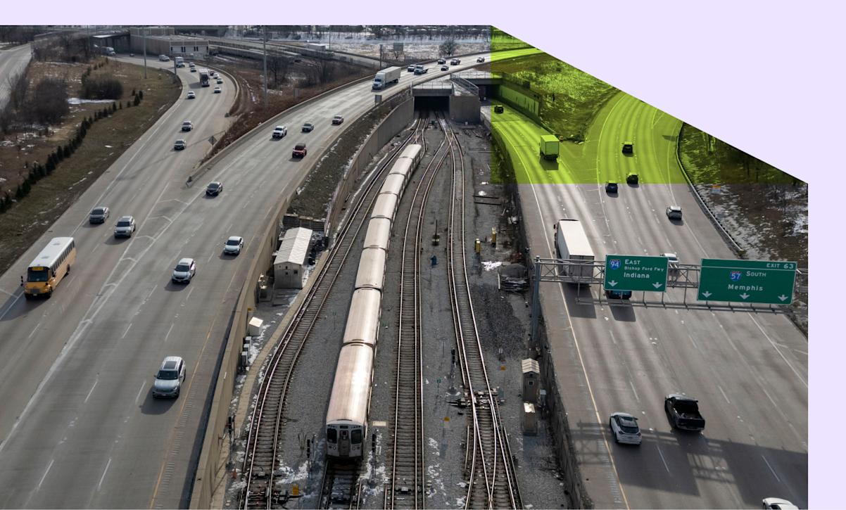 A train travels Chicago's local transit system between two freeways