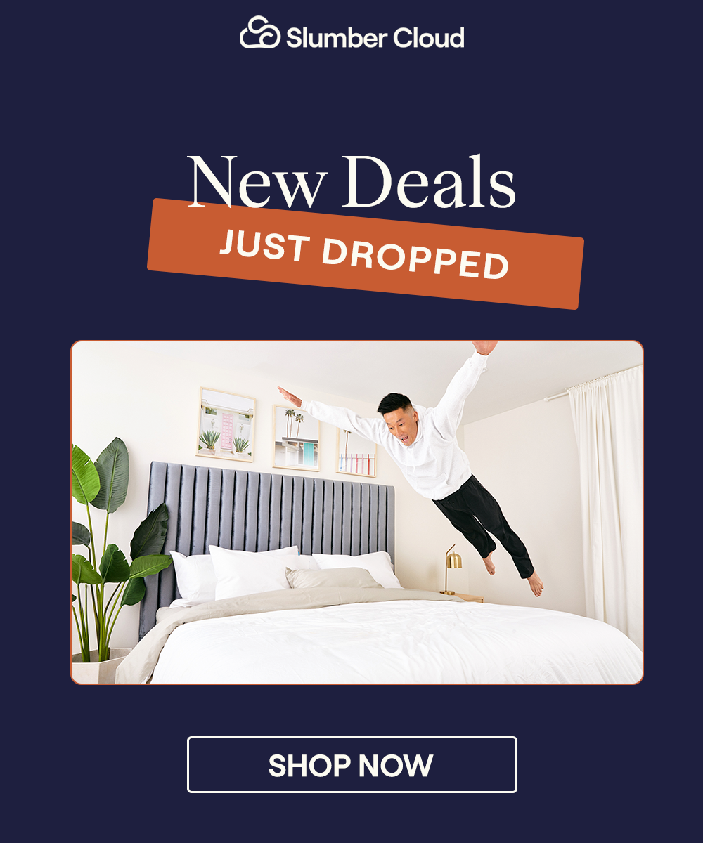 A man jumping onto a bed