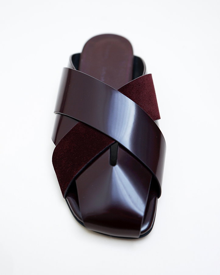 Still life image of Slant Cross Slides in Brushed Calf and Calfsuede in Merlot on a white background