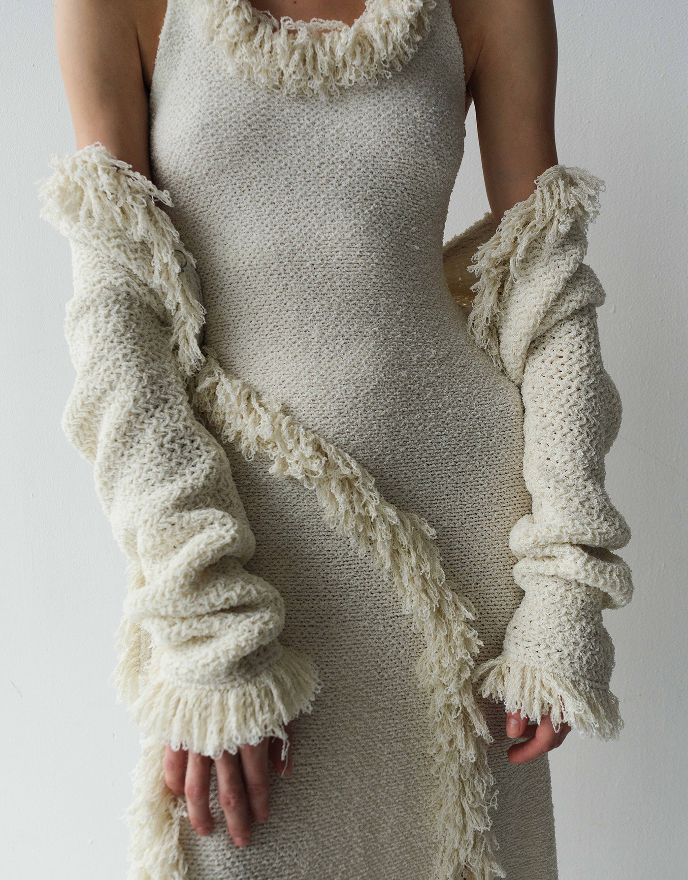 Cropped image of model wearing the Nilo Dress in Textured Jacqaurd and the Nilo Top in Textured Jacquard in Off White with the top slung off her shoulders