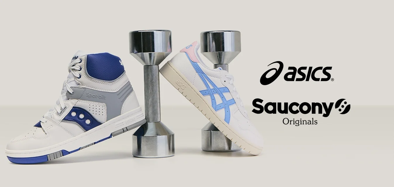 Due sneakers bianche e blu di stili diversi in equilibrio su due manubri metallici su uno sfondo semplice.