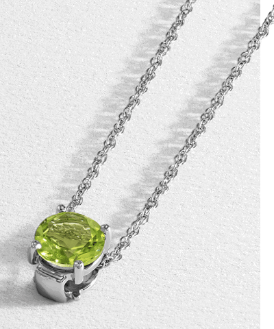 White gold green peridot gemstone solitaire pendant necklace on delicate chain.