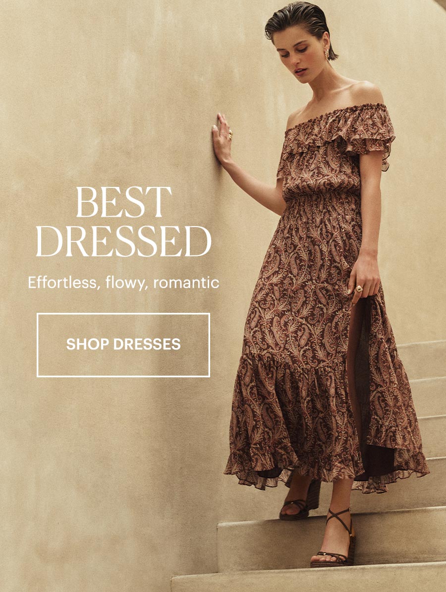 Best Dressed - Effortless, flowy, romantic. Featuring a woman in an off-the-shoulder midi dress and brown leather wedge sandals stepping down a beige stone staircase. Shop Dresses.