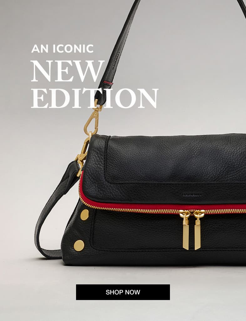 Close-up hero image of the Hammitt Beverly Med in Black/Brushed Gold Red Zip, highlighting its pebbled leather, signature rivets, brushed gold hardware, and iconic red zipper accent.