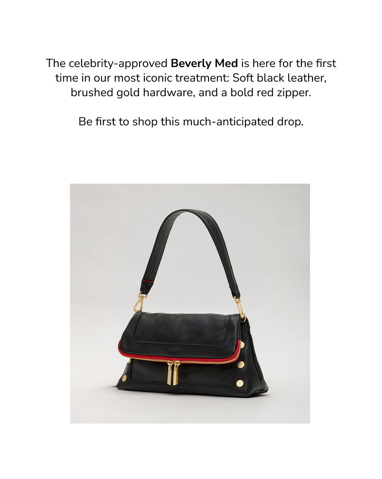 The Hammitt Beverly Med in Black/Brushed Gold Red Zip pebbled leather displayed in a studio setting, featuring a structured flap silhouette, brushed gold hardware, signature rivets, and the iconic red zipper detail.