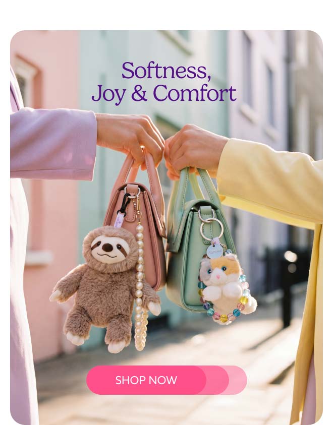 Two girls holding up purses with Warmies Bag Charms styled on them. Shop Now.
