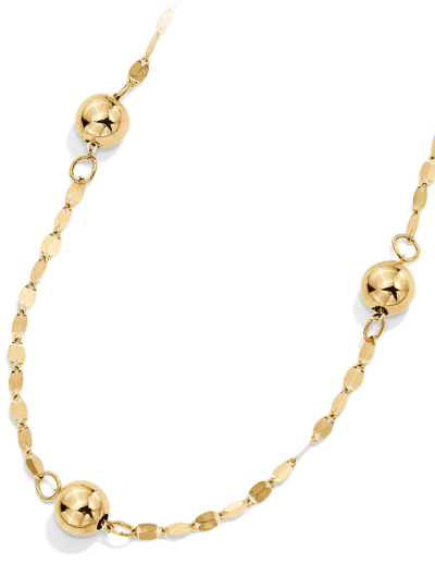 Yellow gold station necklace with polished gold beads.