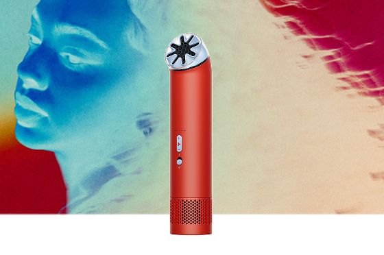Dyson HushJet Mini Cool fan in Carnelian/Sky next to a model.
