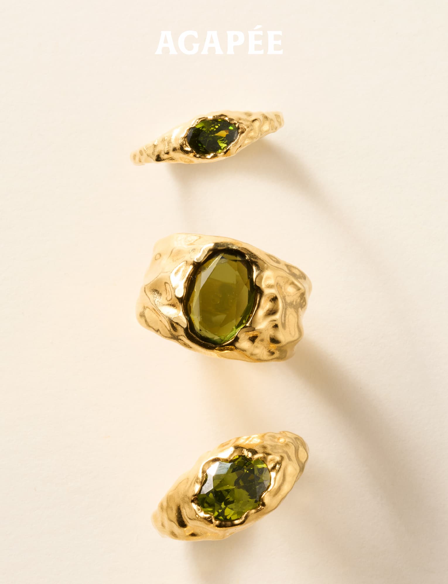 Agapée — three textured gold rings set with olive-green stones