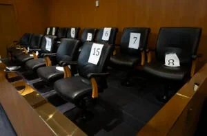 An empty jury box in a pre-trial courtroom.