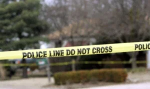 Police tape hangs across a street in front of a house in Park City, Kansas.