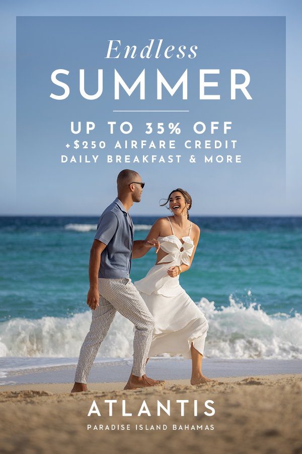 Make It Count: Final chance, every 3rd night free at Atlantis Bahamas. | A man and a woman joyfully posing on a white sand beach by the ocean.