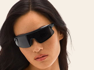 Image of woman wearing black wraparound sunglasses