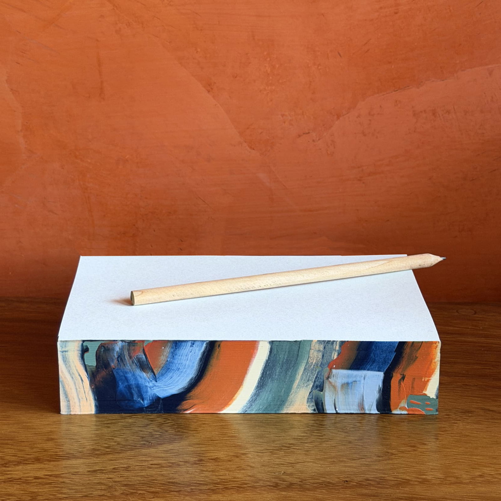 Swirl Pads, hand-painted edge in navy, coral, and cream