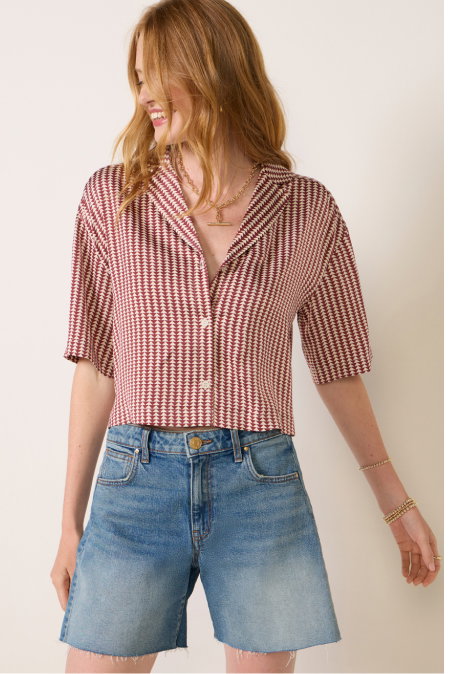 Image of model in cute red white striped button down top with cutoff denim shorts from EVEREVE