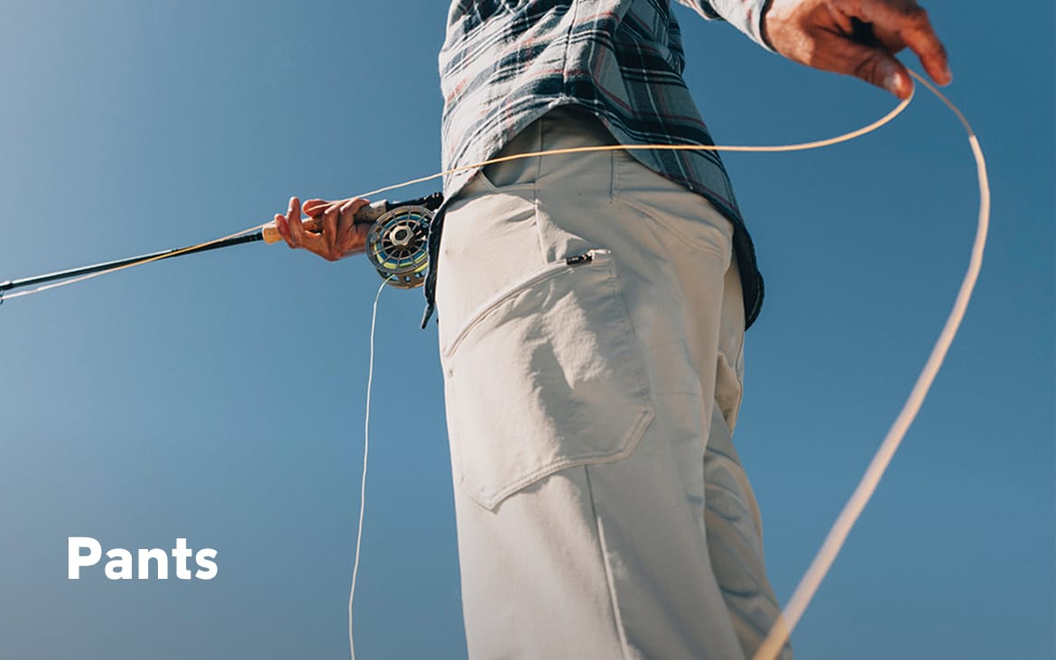 Waist-down image of a man wearing white pants and holding a fishing rod with text: Pants