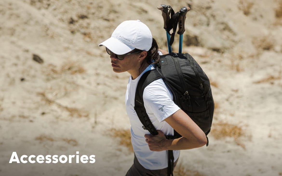 A woman hiking in a rocky landscape, wearing a backpack with text: Accessories