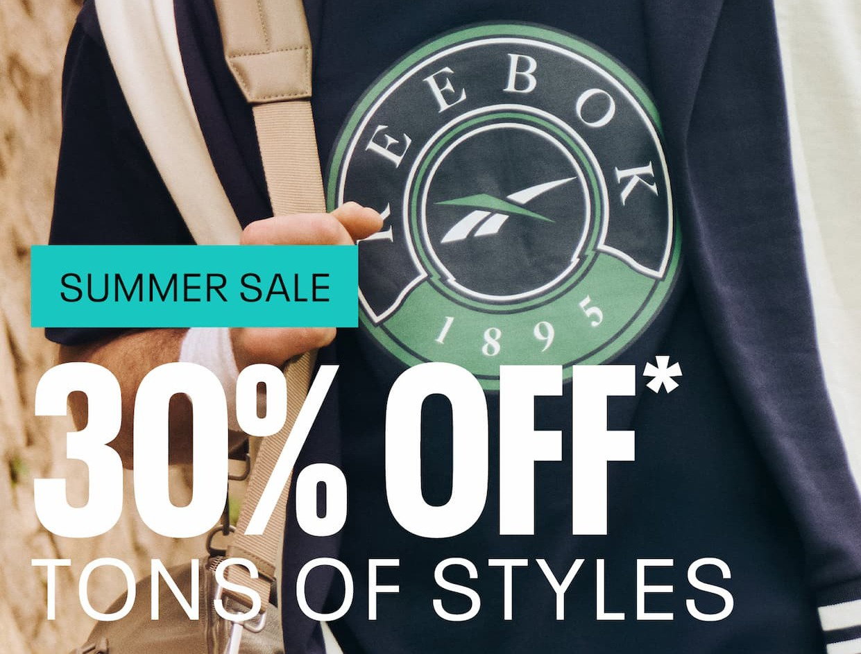 Close-up of a Reebok shirt with a heritage logo and shoulder bag. Text reads: “SUMMER SALE. 30% OFF tons of styles.”
