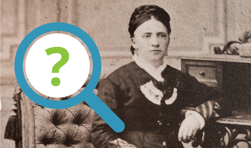 A vintage portrait of a seated woman in formal attire, partially obscured by a large magnifying glass icon with a question mark.