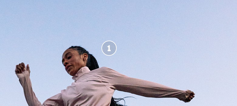 A woman runner leaping.