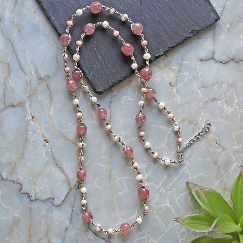 Elegant beaded necklace featuring pink tourmaline, pearl, and rose gold beads on marble background by MGR My Gems Rock.