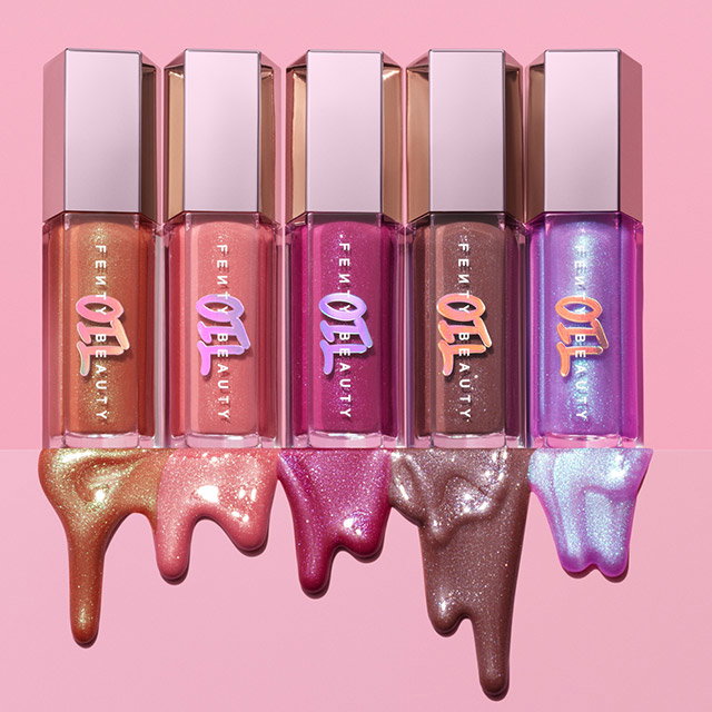 Five Fenty Beauty lip glosses in varied colors with gloss streaks below. 