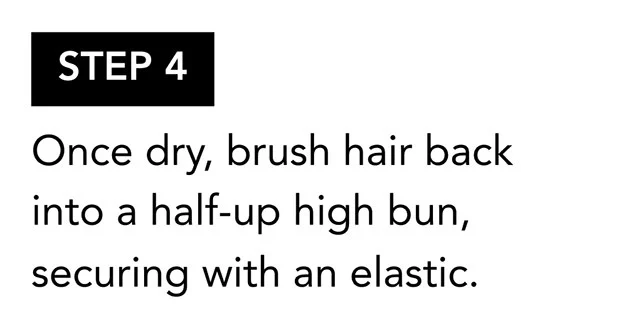 STEP 4 | Once dry, brush hair back into a half-up high bun, securing with an elastic.