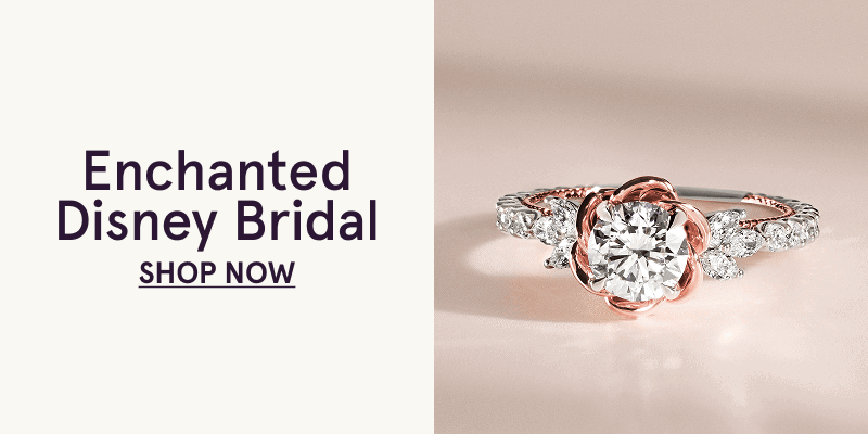 Round diamond cradled by rose gold floral petal setting, flanked by diamond leaves on diamond band. Enchanted Disney Bridal. Click here to shop now