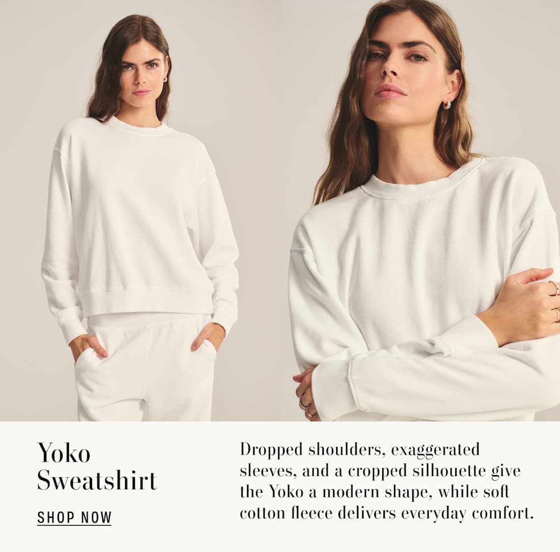 Text reads: Yoko Sweatershirt. Dropped shoulders, exaggerated sleeves, and a cropped silhouette give the Yoko a modern shape, while soft cotton fleece delivers everyday comfort.