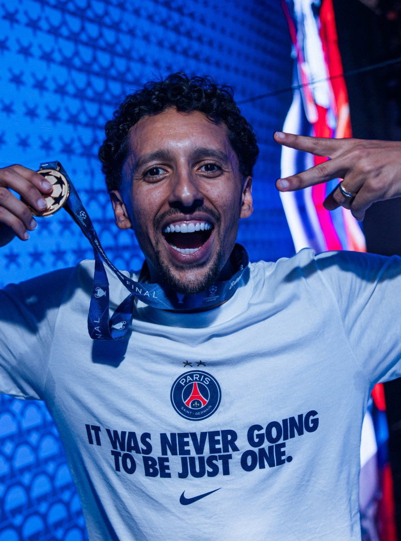 Marquinhos celebrates wearing a PSG "It Was Never Going To Be Just One" t-shirt while holding his Champions League winners medal.
