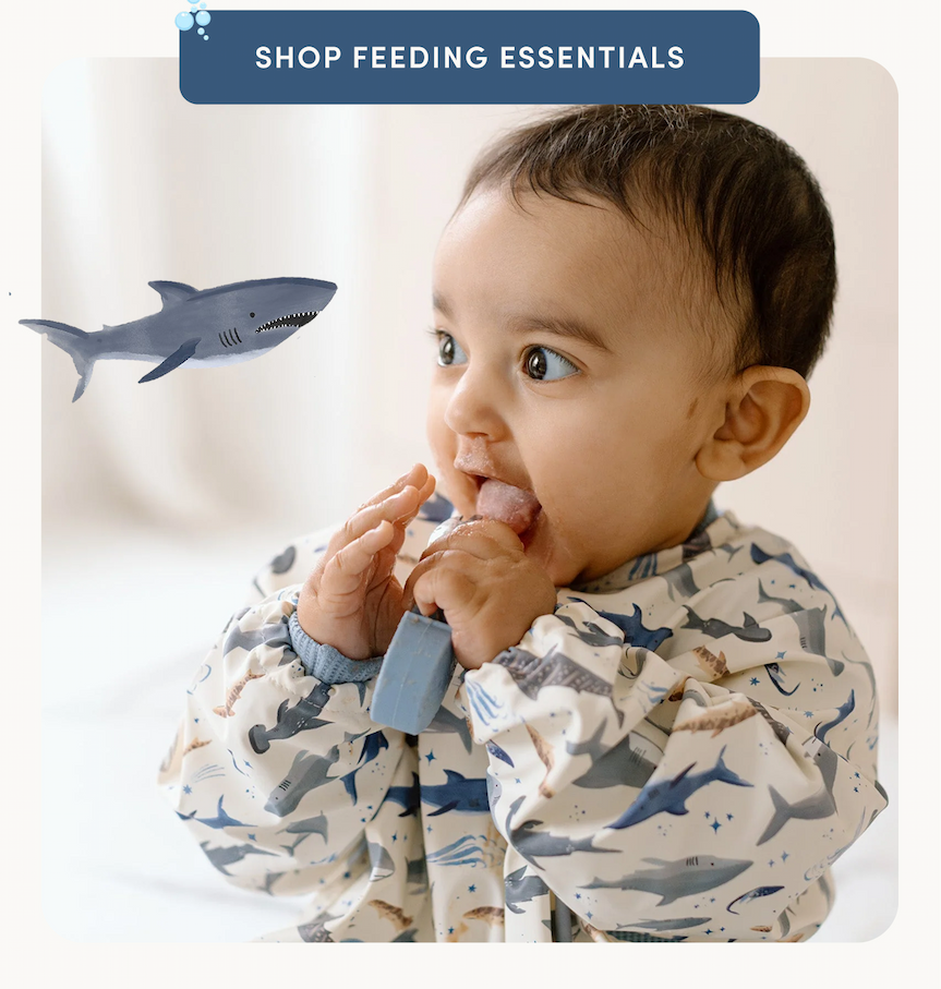 blue button with cream text on a photo of a baby licking a spoon and wearing a shark printed long sleeve bib