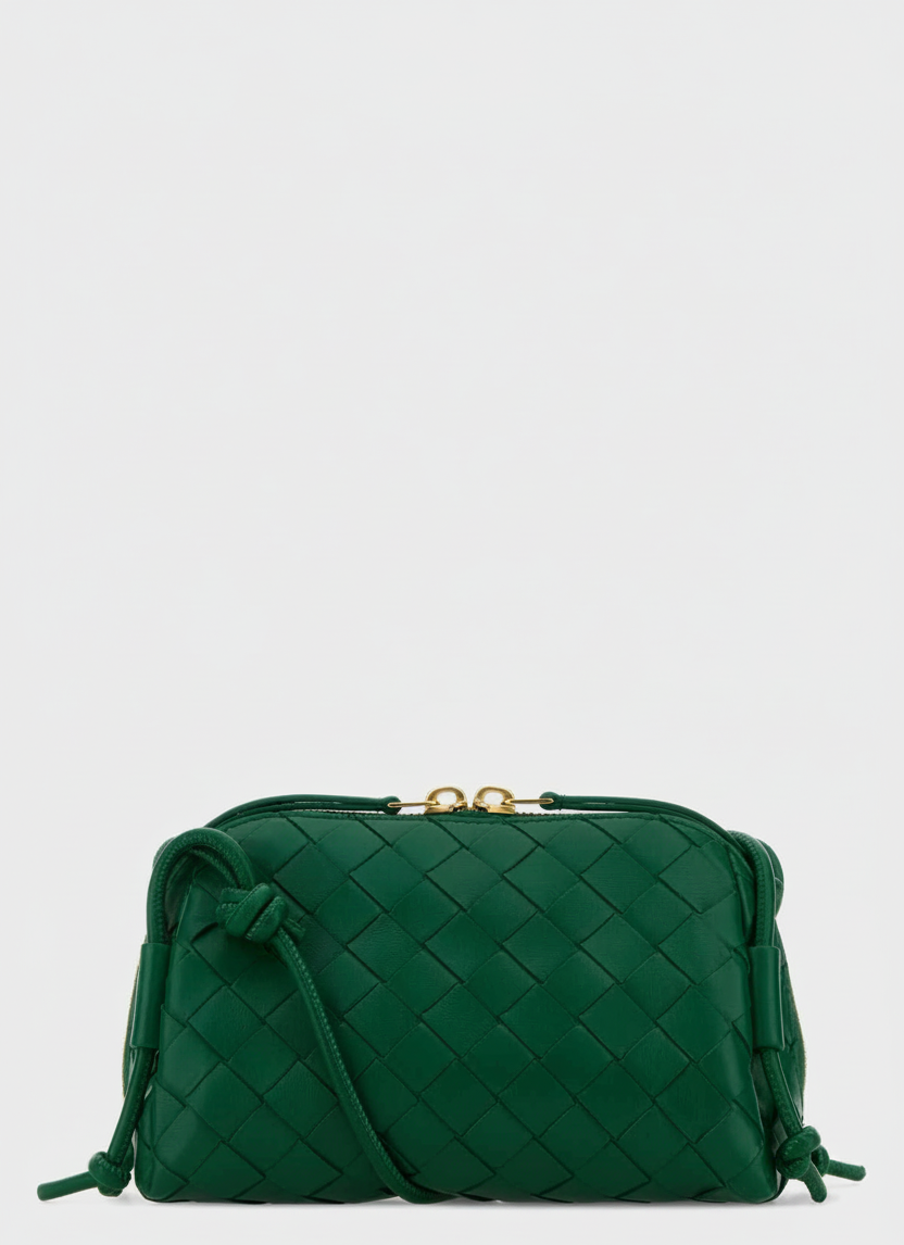 Green woven leather crossbody bag with gold hardware and knotted details.