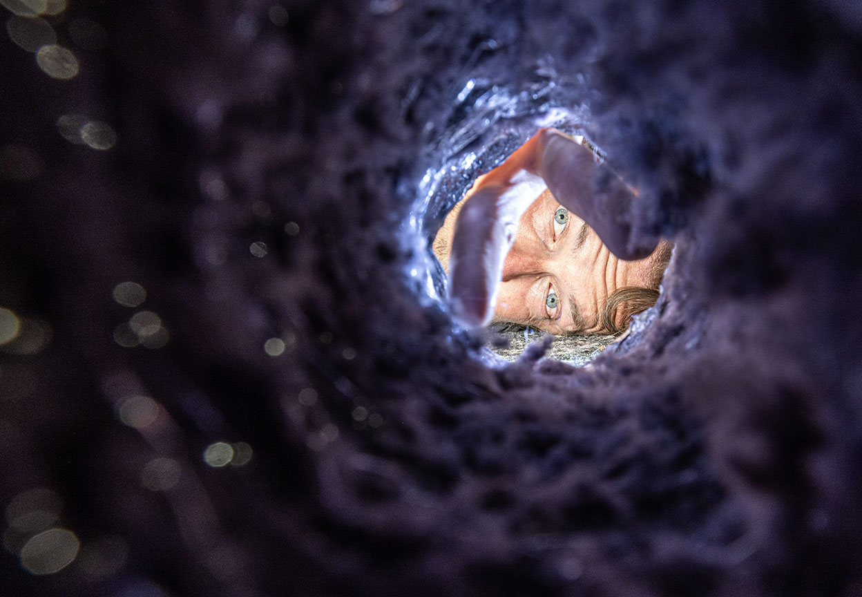Person inspects the heavy lint buildup inside a dryer vent