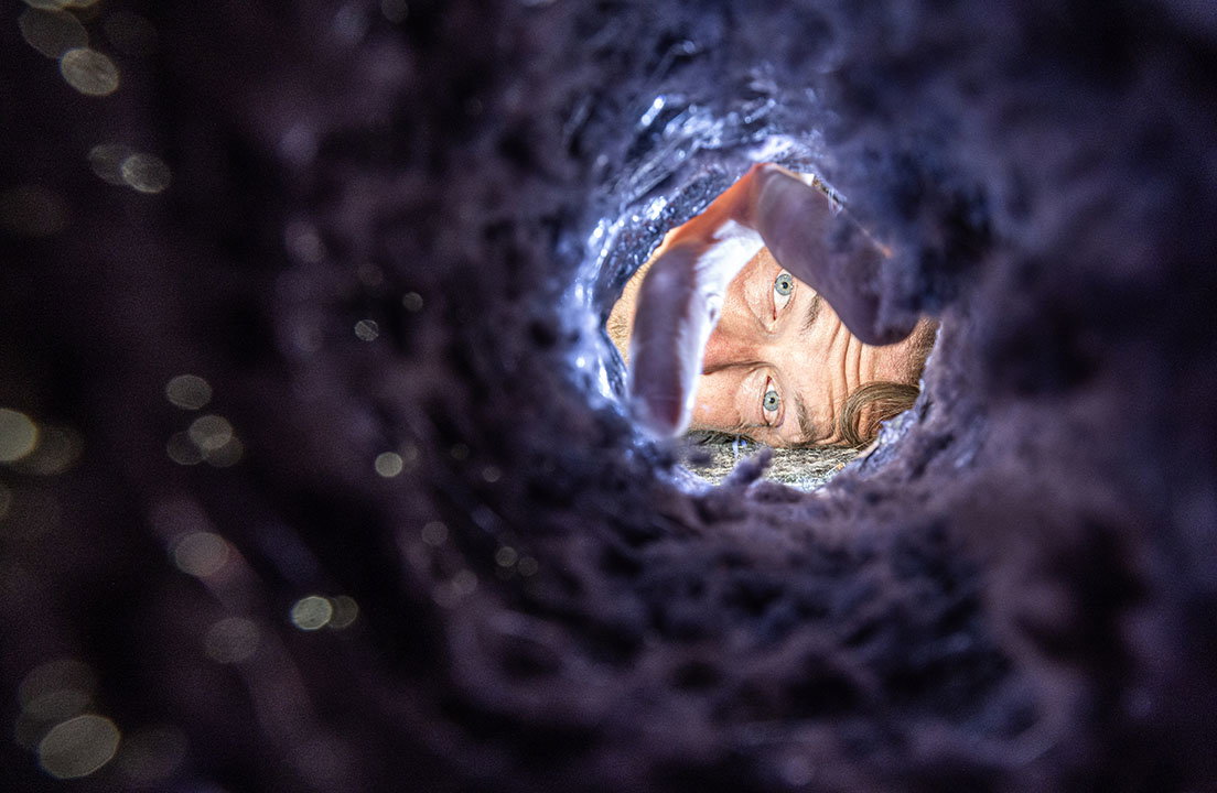 Person inspects the heavy lint buildup inside a dryer vent