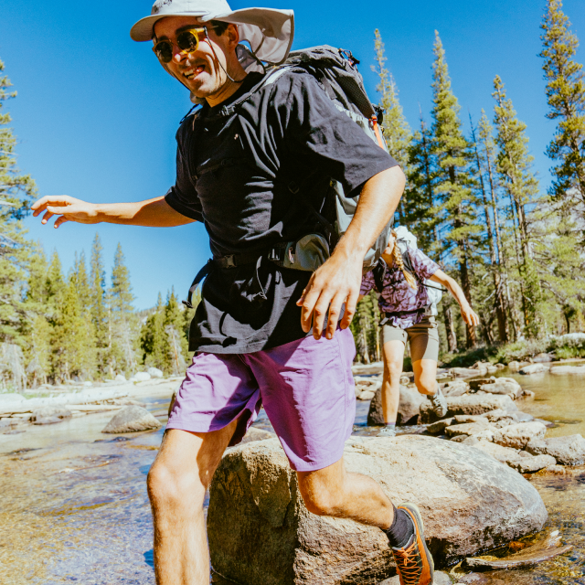 Men running through river rocks in Stryder™ Short.