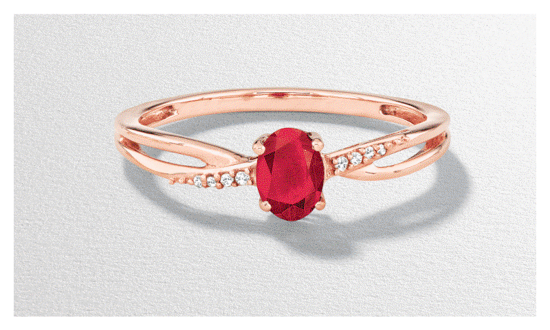 Rose gold red ruby crossover ring. White gold green gemstone tennis bracelet. White gold green gemstone pendant necklace.