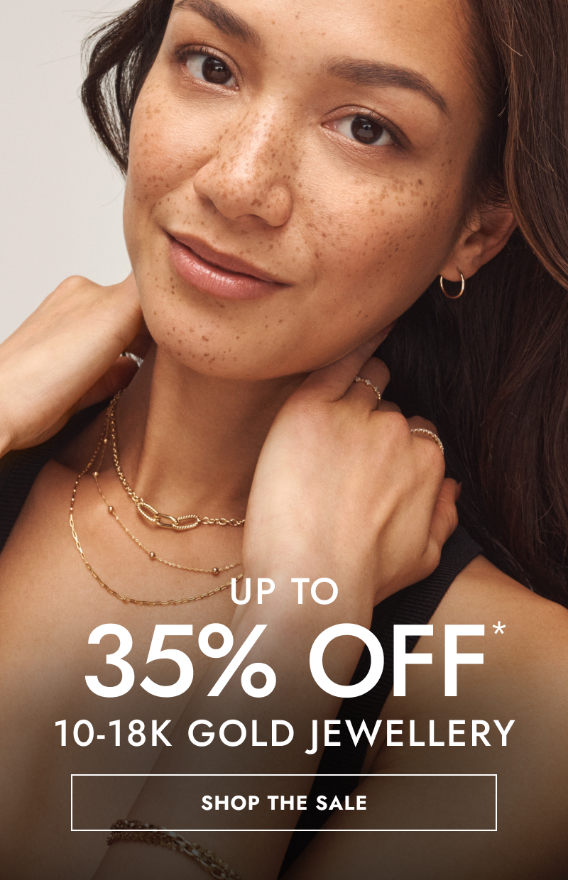 Woman wearing layered yellow gold necklaces, hoops and rings. Up to 35% Off 10-18K gold jewellery. Click shop the sale.