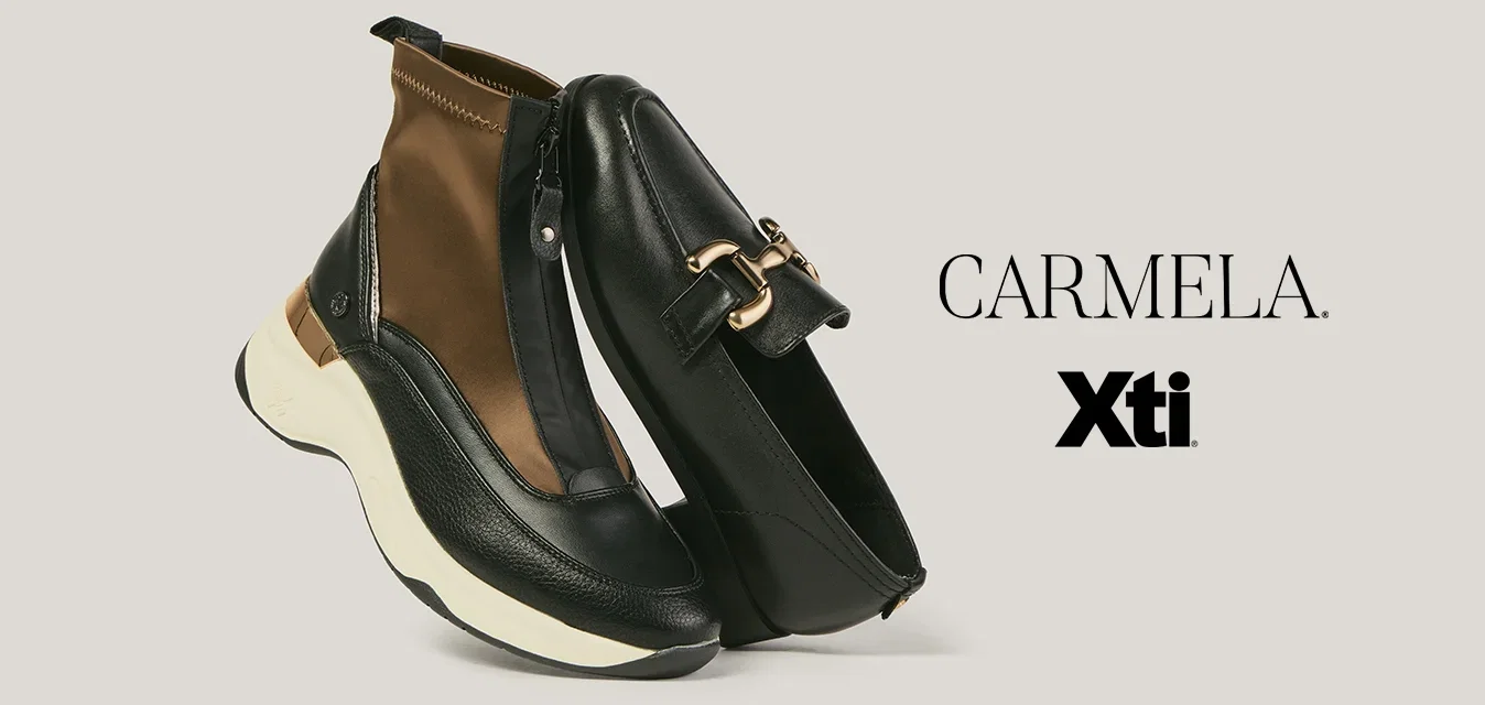 Mocasín de cuero negro con hebilla de oro junto a zapatilla negra y marrón con cremallera y suela blanca sobre fondo neutro.