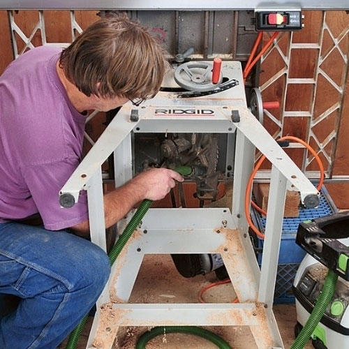 Vacuuming table saw interior