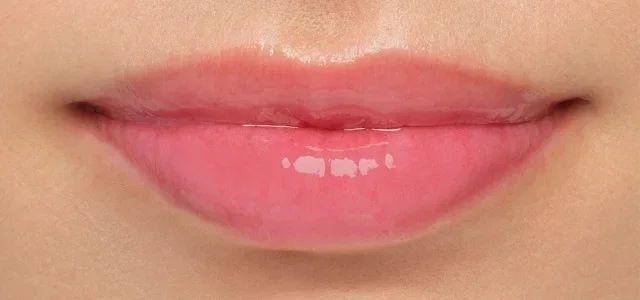 Close-up of lips wearing Extra Blushing Lip Oil.