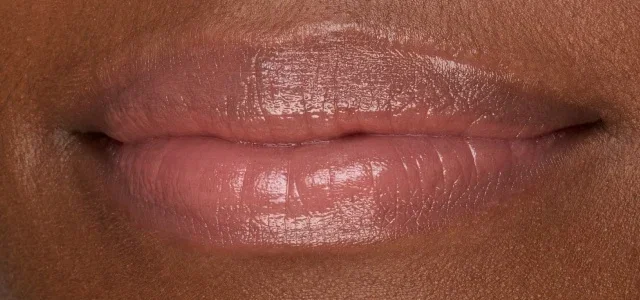 Close-up of lips wearing Extra Color Shine Lipstick.