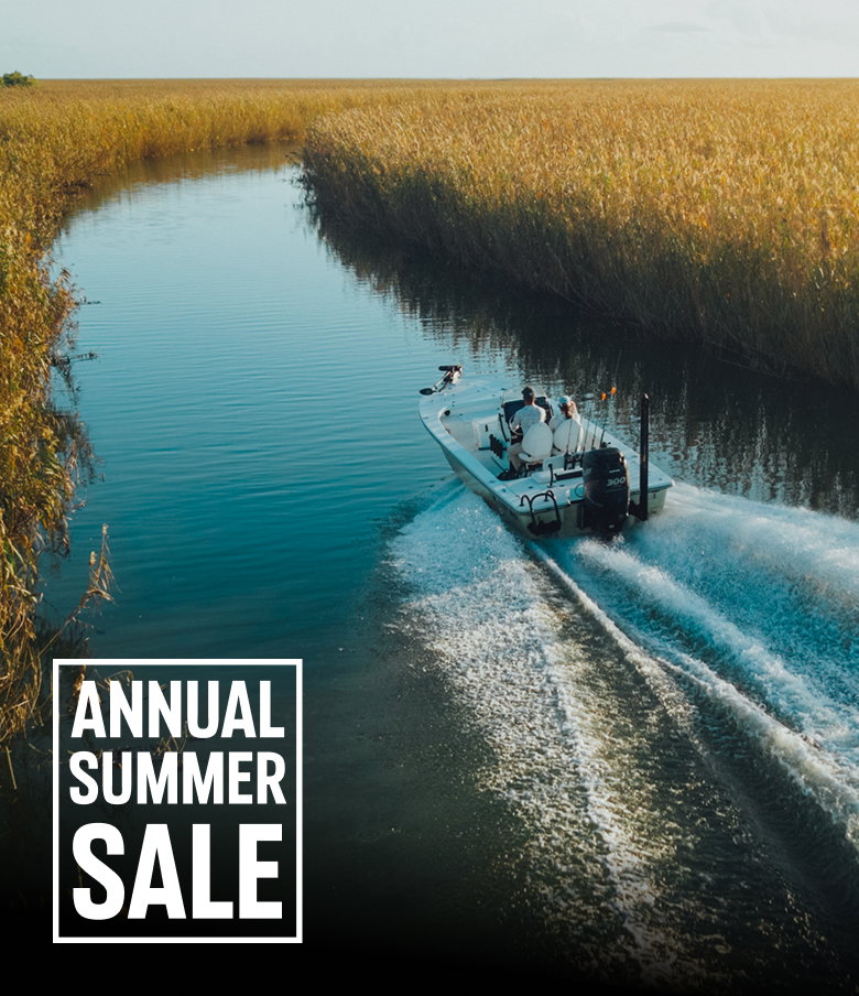 Two anglers on a boat in the water with text: ANNUAL SUMMER SALE 